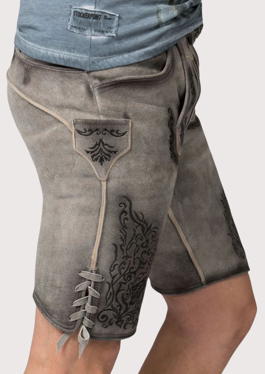 Men’s lederhosen with antique-style buttons and detailed floral stitching for festive occasions.