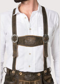 Traditional Bavarian Bundhosen in rustic suede leather with detailed embroidery and authentic Alpine craftsmanship
