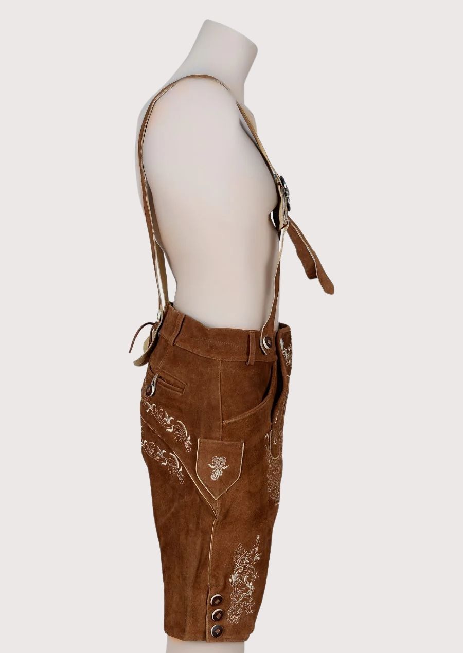 Traditional Bavarian lederhosen featuring embroidered leather braces, decorative front panel, and rustic brown suede
