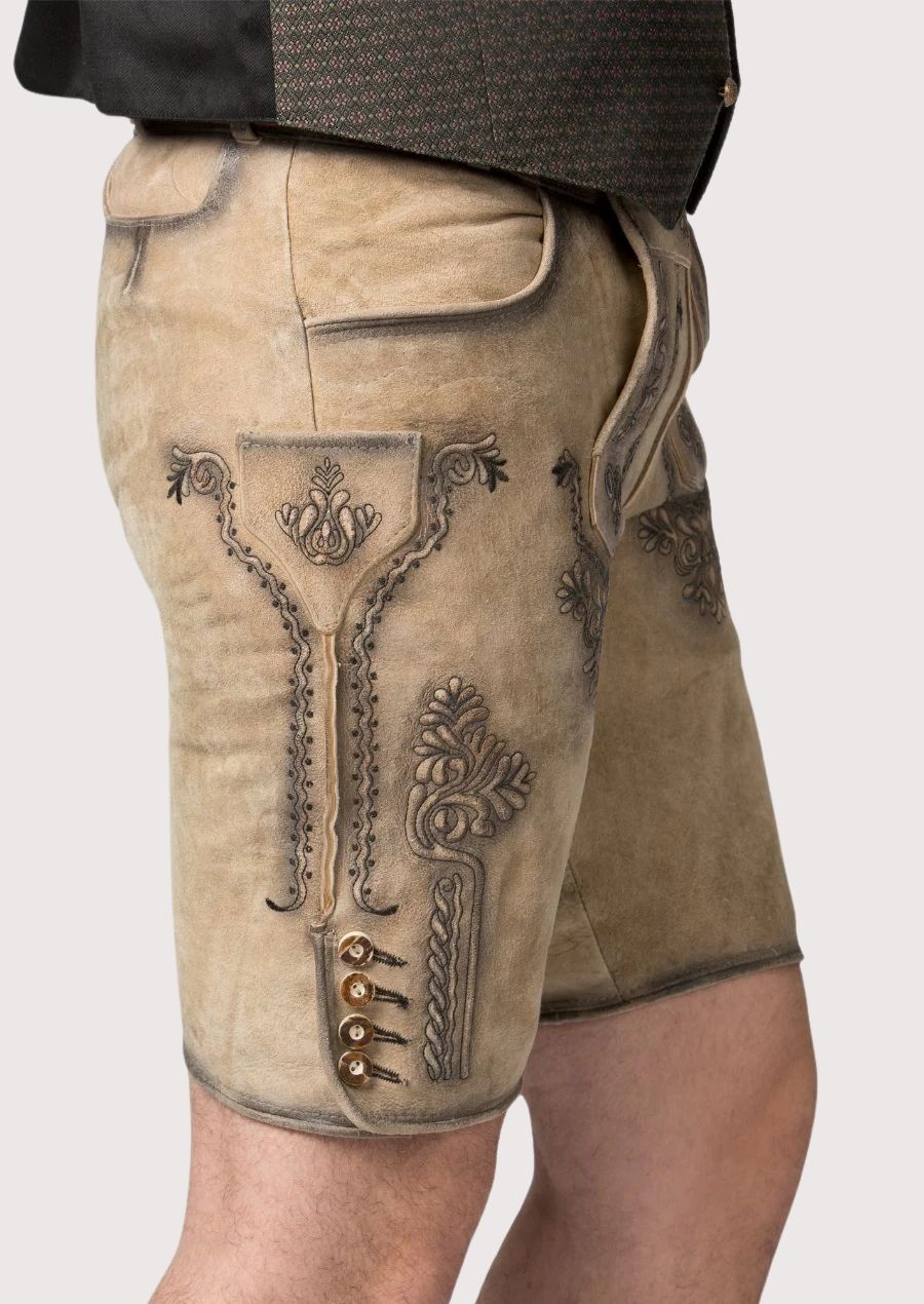 Traditional Bavarian lederhosen in light beige suede leather with ornate embroidered detailing