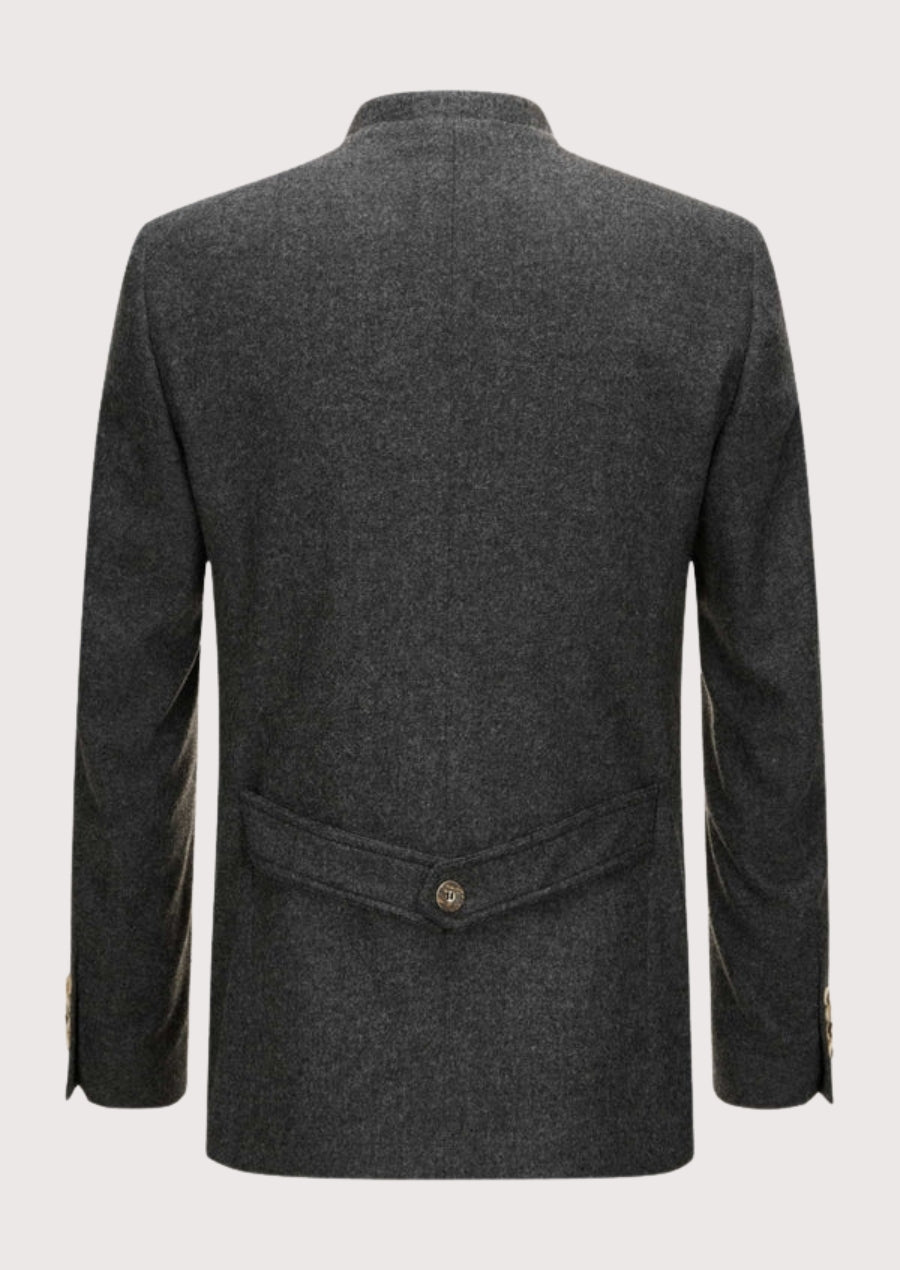 Classic Bavarian loden jacket in charcoal grey with stand-up collar, natural buttons, front flap pockets, and structured back waist detail.