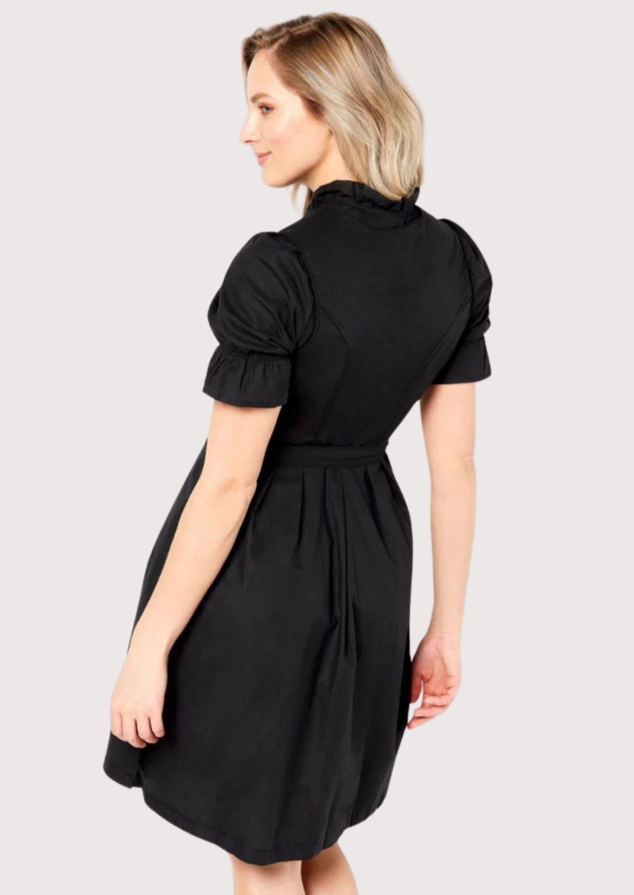 Traditional Alpine Dirndl dress in black with a structured bodice, ribbon waist tie, puff sleeves, and timeless Bavarian craftsmanship.
