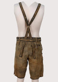 Traditional brown lederhosen made from premium goatskin suede with ornate embroidery and adjustable suspenders
