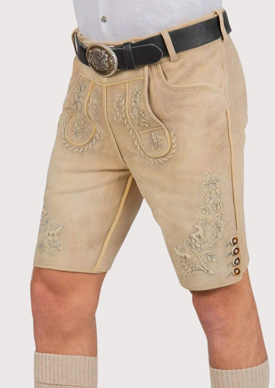 Bavarian cream suede lederhosen showcasing embroidered deer accents and decorative folk art patterns