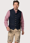 Deep blue alpine vest worn over checkered shirt