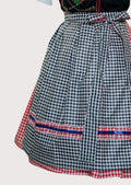 Traditional German Dirndl dress featuring red gingham side panels, black embroidered bodice, white blouse, and checkered apron for Oktoberfest celebrations.