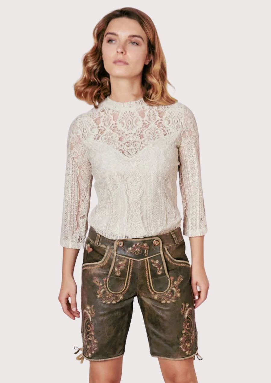 Vintage women's lederhosen shorts in distressed brown suede featuring colorful floral embroidery and authentic Bavarian styling.