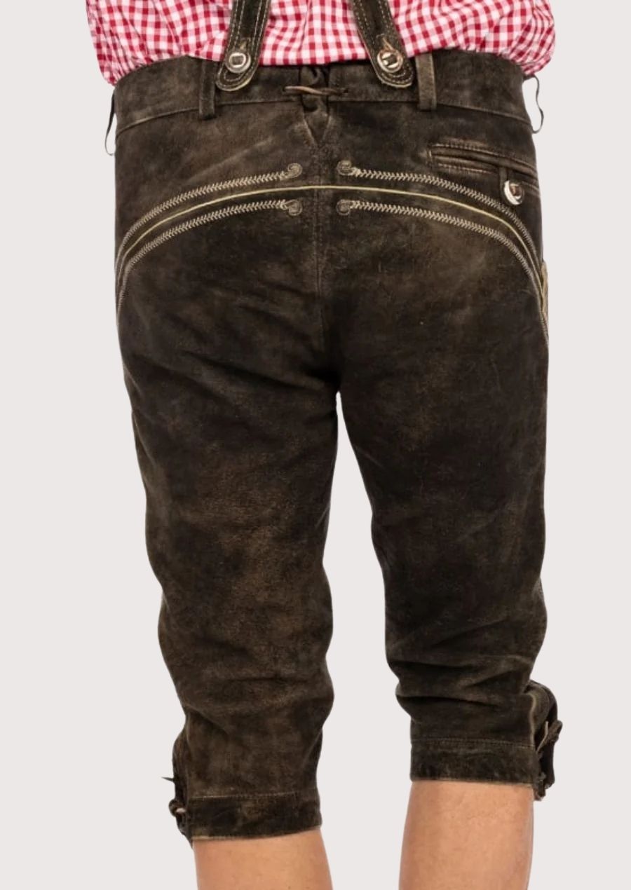 Vintage suede Bundhosen showcasing ornate embroidery, knee-length cut, and adjustable traditional suspenders