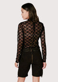 Women's Alpine black leather shorts showcasing embroidered floral accents, classic lederhosen details, and timeless folk fashion.
