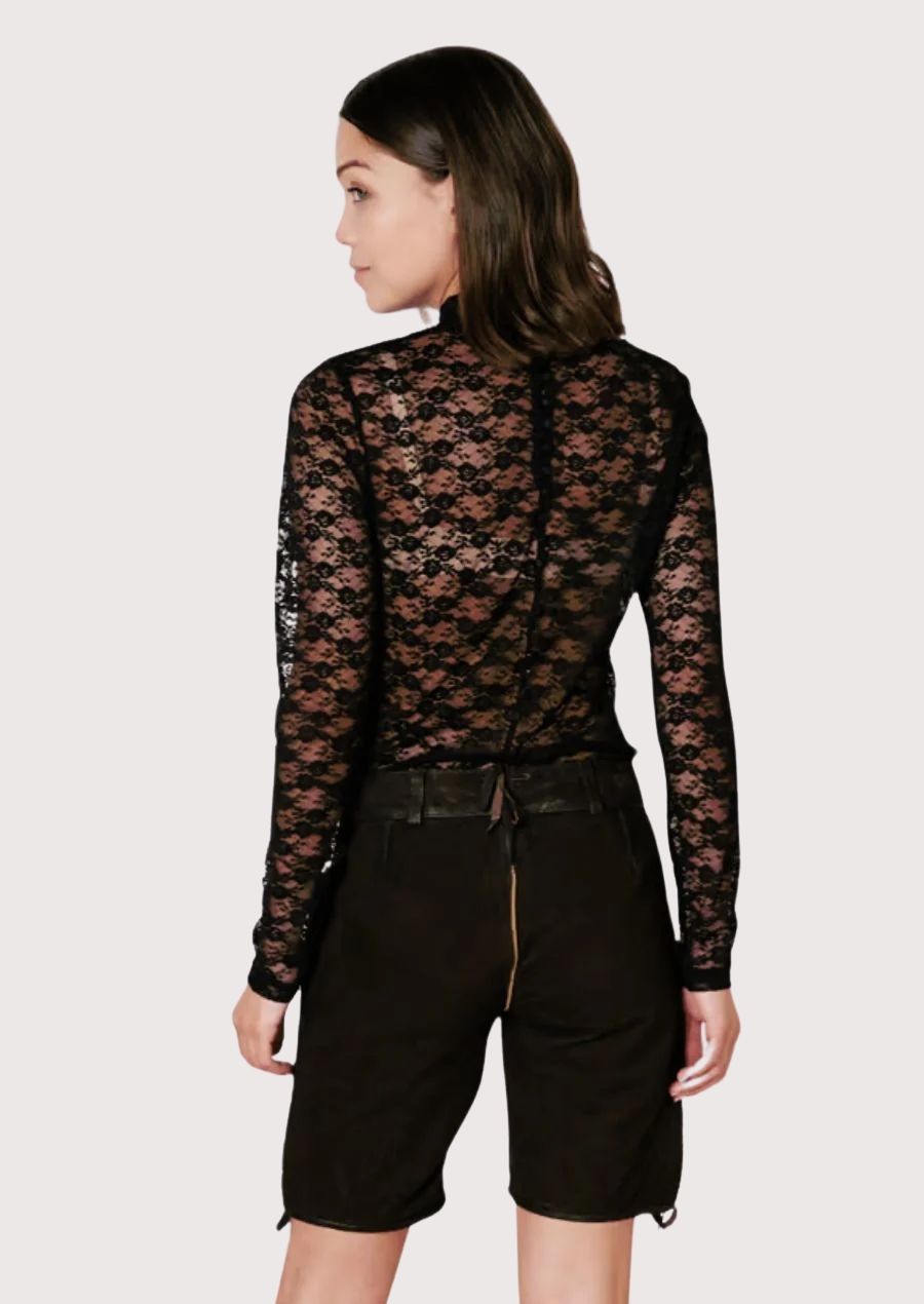 Women's Alpine black leather shorts showcasing embroidered floral accents, classic lederhosen details, and timeless folk fashion.