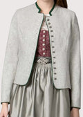 Elegant women's Alpine heritage jacket in light grey wool with green trim, decorative metal buttons, and traditional craftsmanship.