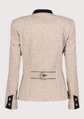 Women’s beige traditional alpine jacket made from structured wool fabric.