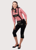 Woman wearing black bundhosen with traditional suspenders