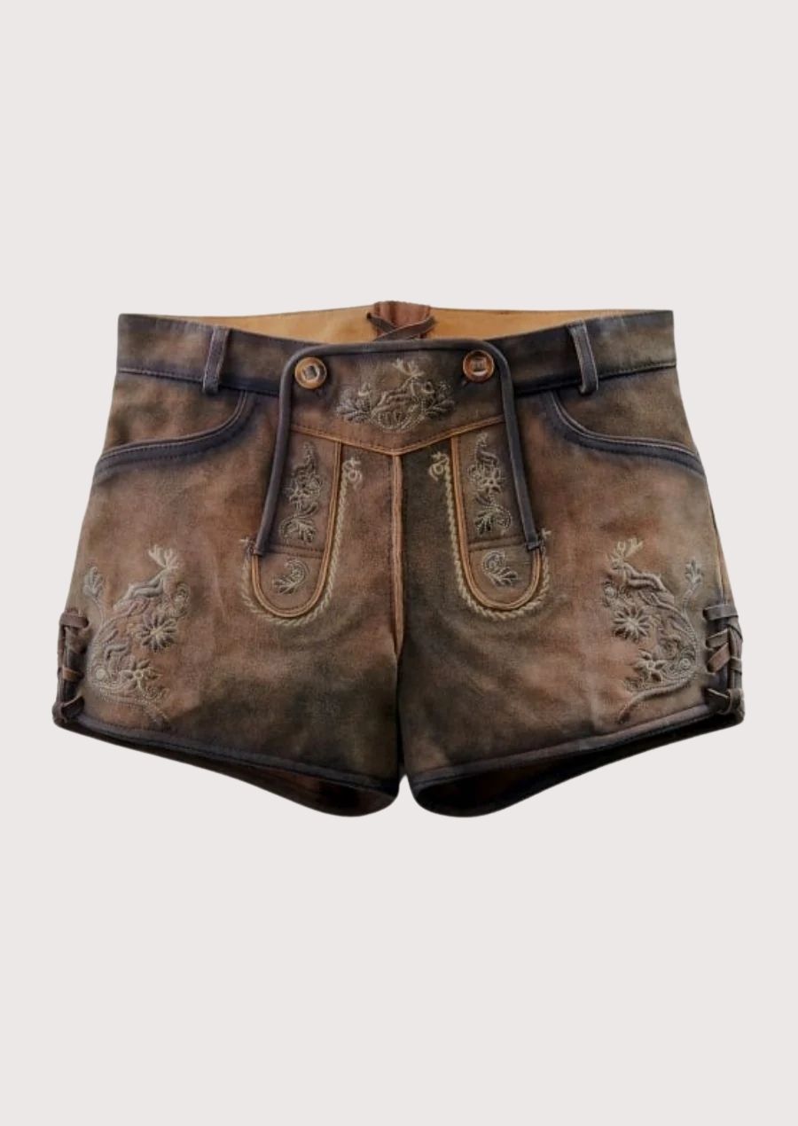 Front view of women’s brown lederhosen shorts paired with black top and alpine embroidery