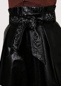 Elegant women’s leather shorts paired with sleeveless lace top