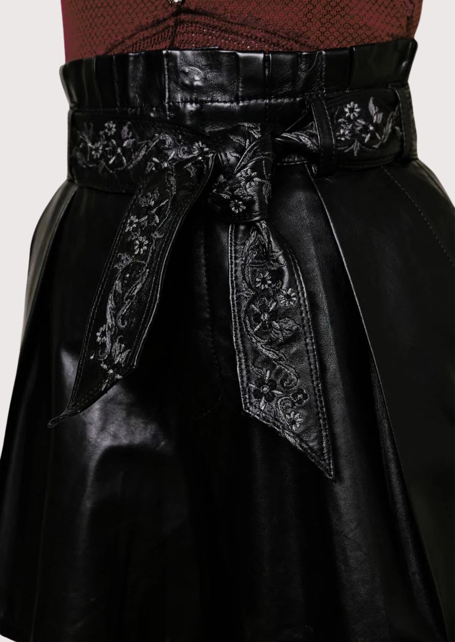 Elegant women’s leather shorts paired with sleeveless lace top