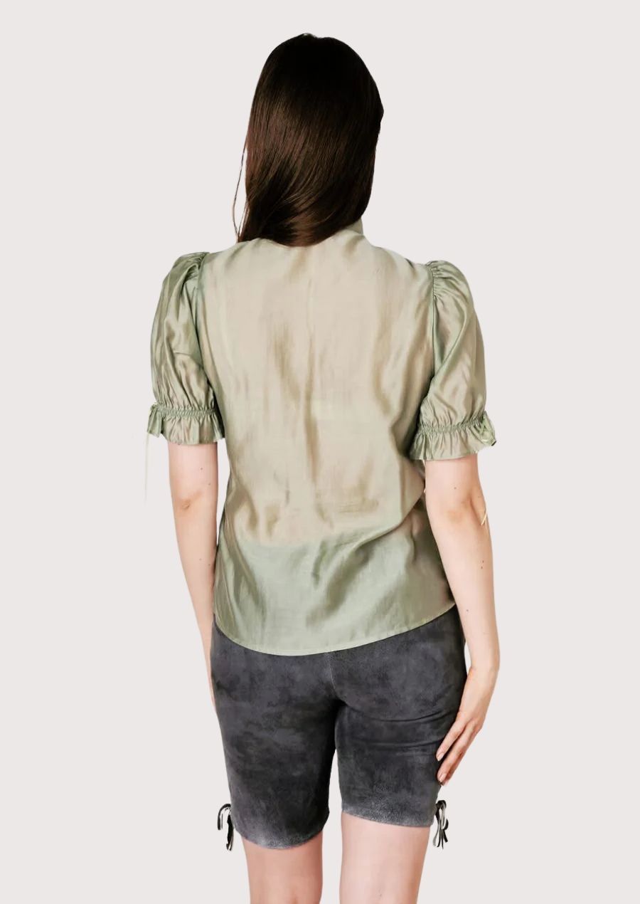 Women's floral gray suede lederhosen style showcasing intricate embroidery and timeless folk fashion appeal.