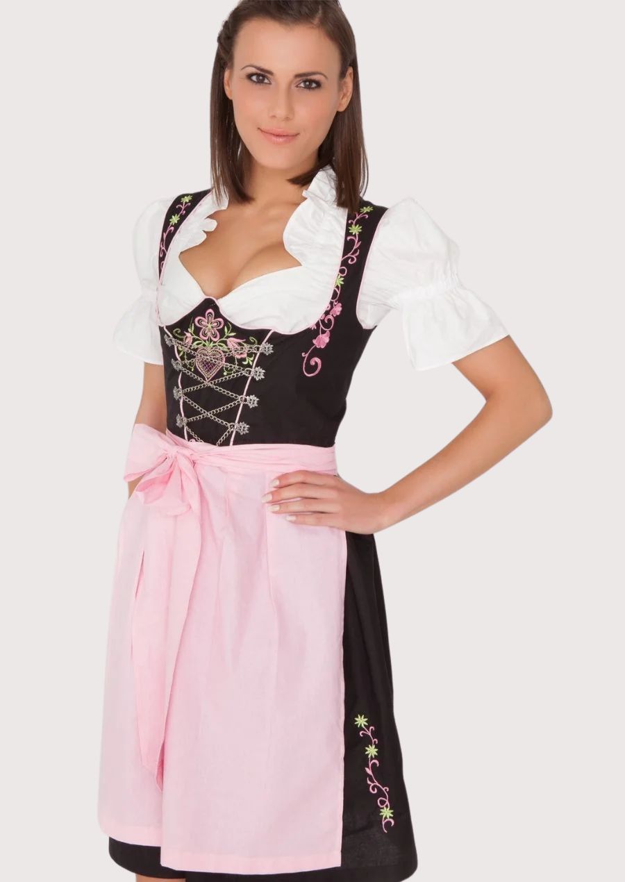 Women's floral embroidered Oktoberfest Dirndl with a fitted lace-up corset, pastel pink apron, black skirt, and classic German Alpine design.