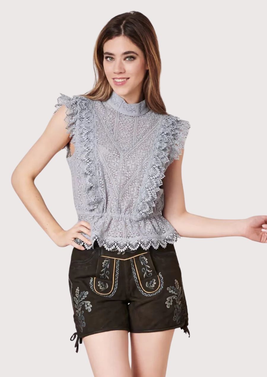Luxury Bavarian lederhosen for women featuring black suede construction, ornate embroidery, and refined traditional styling.