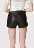 Women’s black leather lederhosen shorts styled with traditional Bavarian motifs