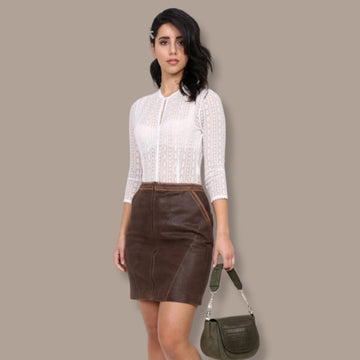 Women wearing lederhosen skirt with white shirt.