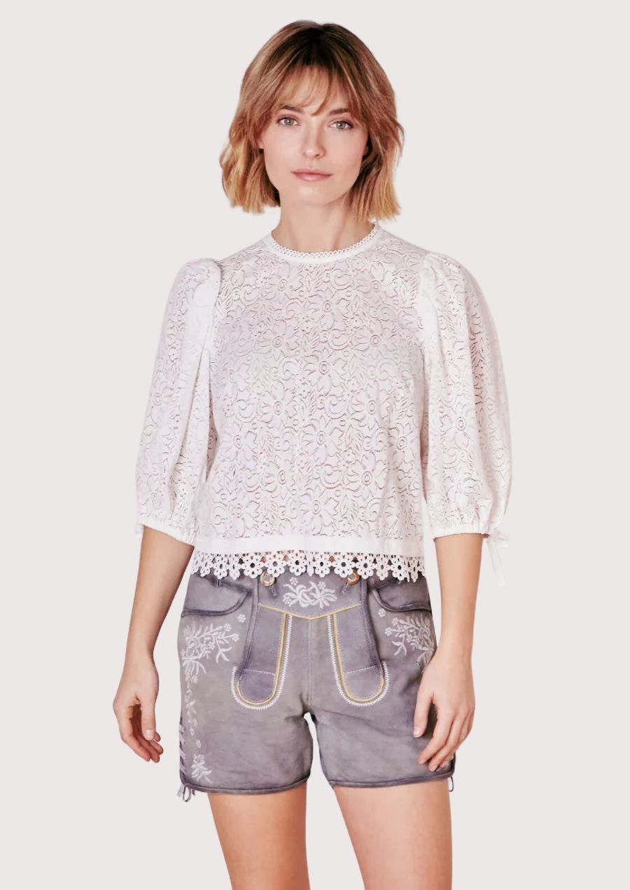 Elegant women's lederhosen with intricate floral embroidery, perfect for Oktoberfest and cultural celebrations.