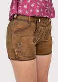 Timeless women’s lederhosen made from soft suede leather with adjustable fit and floral detailing, ideal for Oktoberfest, cultural gatherings, and casual outings.