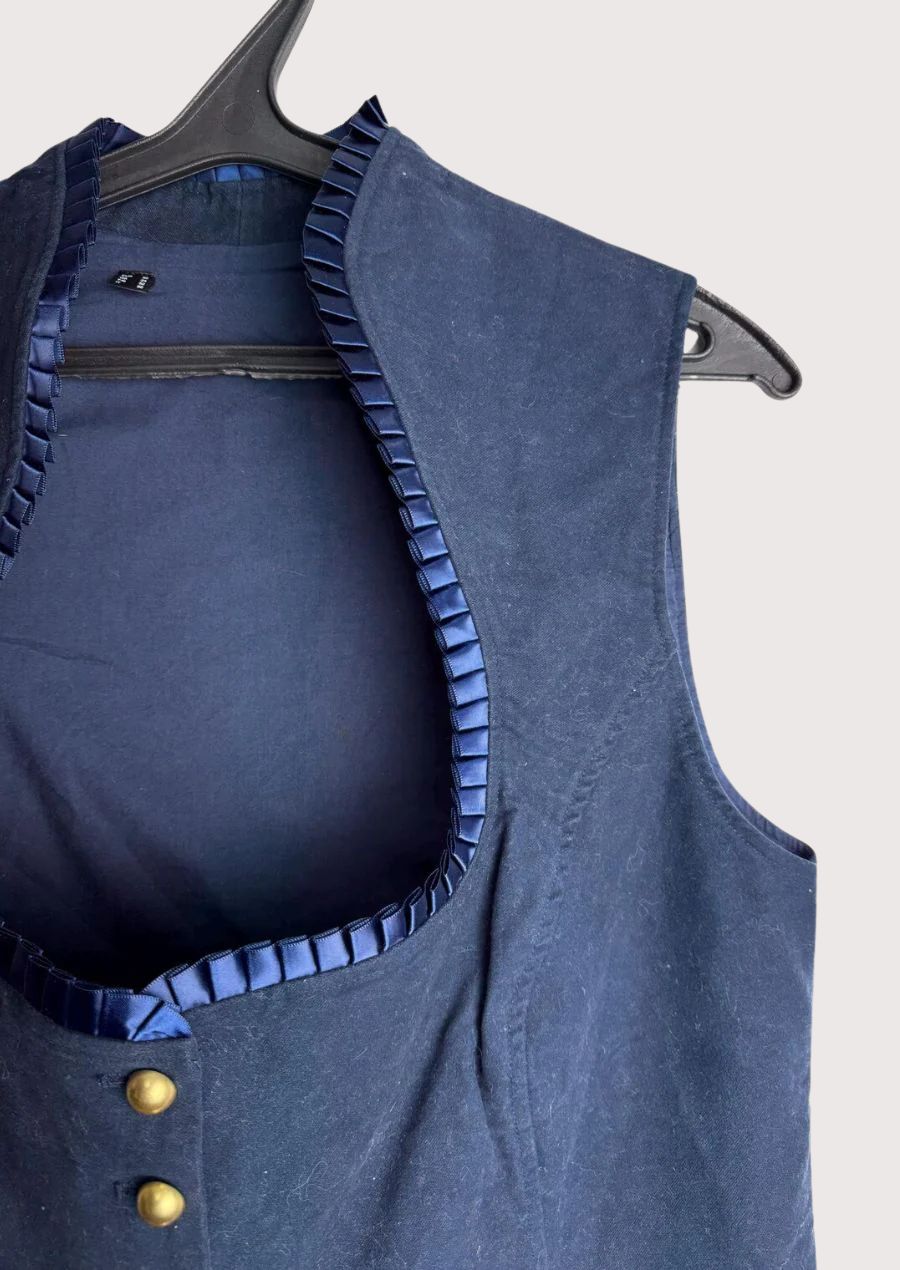 Pleated Trim Trachten Vest featuring tailored craftsmanship, brass buttons, elegant neckline, and traditional Oktoberfest style.