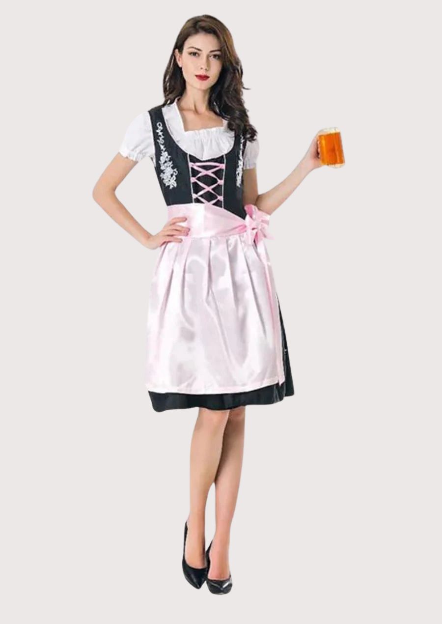 Traditional women's Trachten Dirndl with a fitted black bodice, soft pink apron, floral embroidery, white blouse, and authentic German festival design.