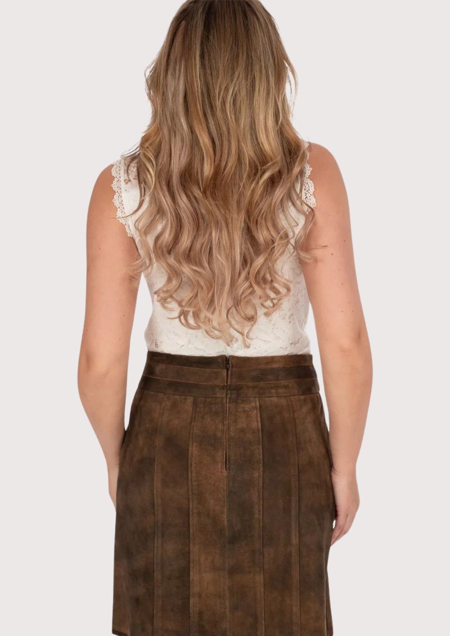 Modern women’s trachten leather skirt styled with lace top